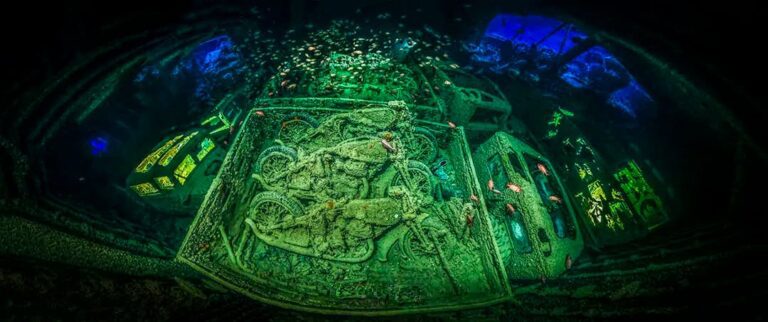 Panoramic view of the cargo deck inside the SS Thistlegorm with the motorcycles in the middle and light to lighten the trucks on the side of the cargo deck, near Sharm el Sheikh, Northern Red Sea, Egypt.