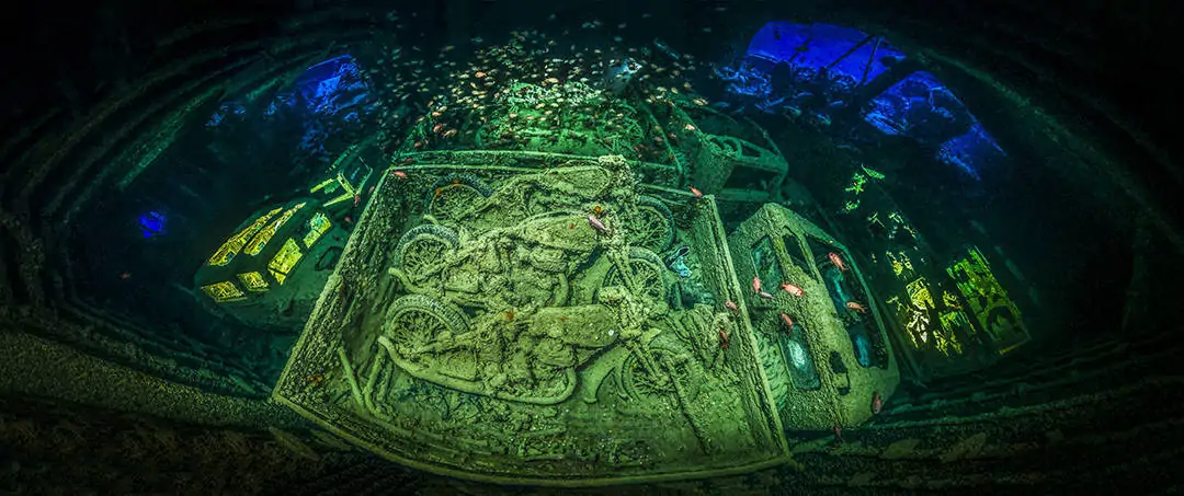 Panoramic view of the cargo deck inside the SS Thistlegorm with the motorcycles in the middle and light to lighten the trucks on the side of the cargo deck, near Sharm el Sheikh, Northern Red Sea, Egypt.