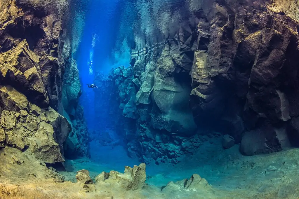 A diver explores the cathedral at Silfra canyon, a deep fault filled with fresh water in the rift valley between the Eurasian and American tectonic plates at Thingvellir National Park, Iceland. In this photo the American plate is on the left and the Eurasian plate on the right.