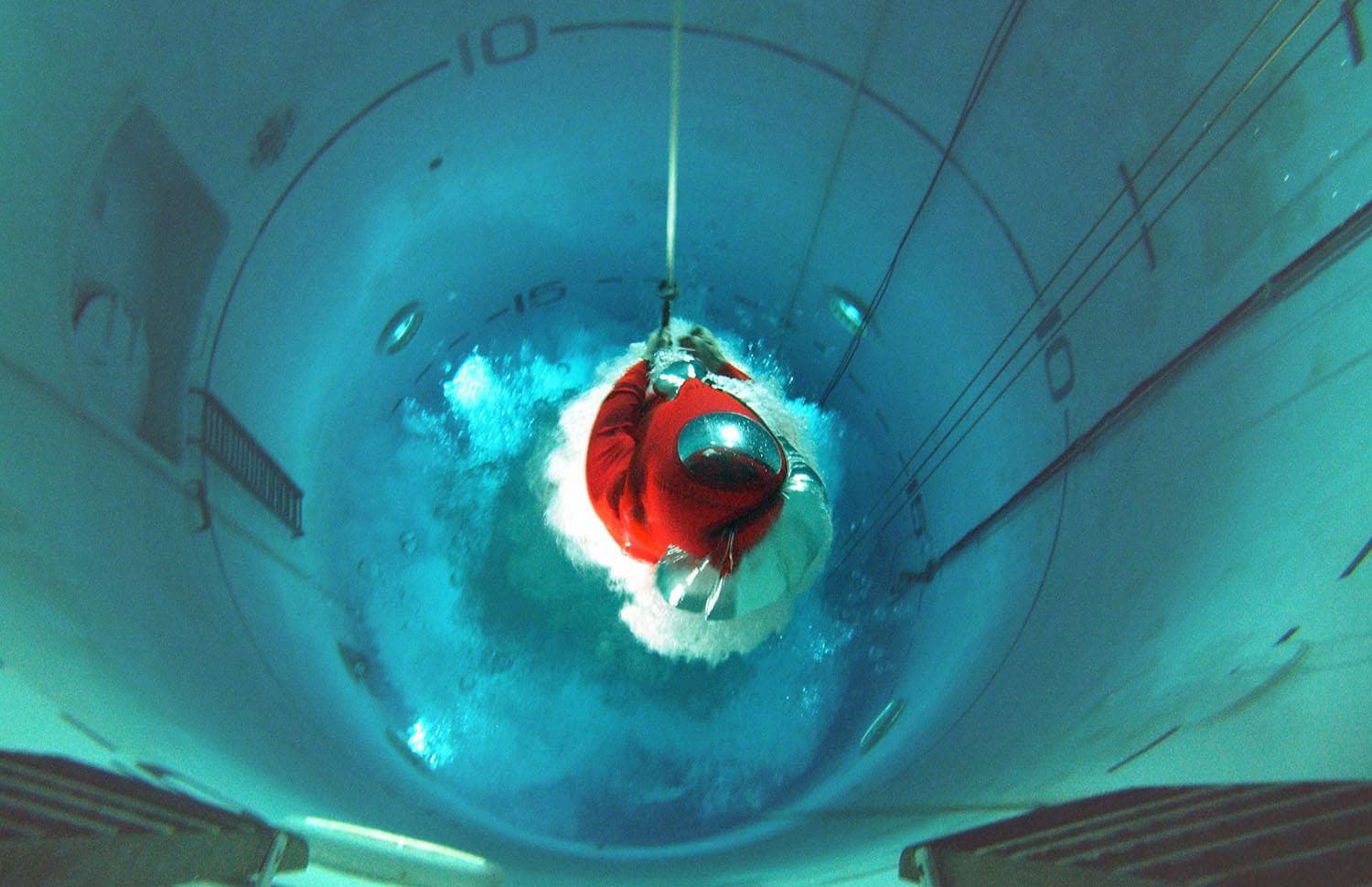 A Royal Navy submariner rises through the tank in 2004