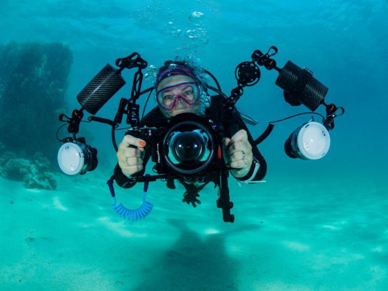 scubadiver with camera equipment