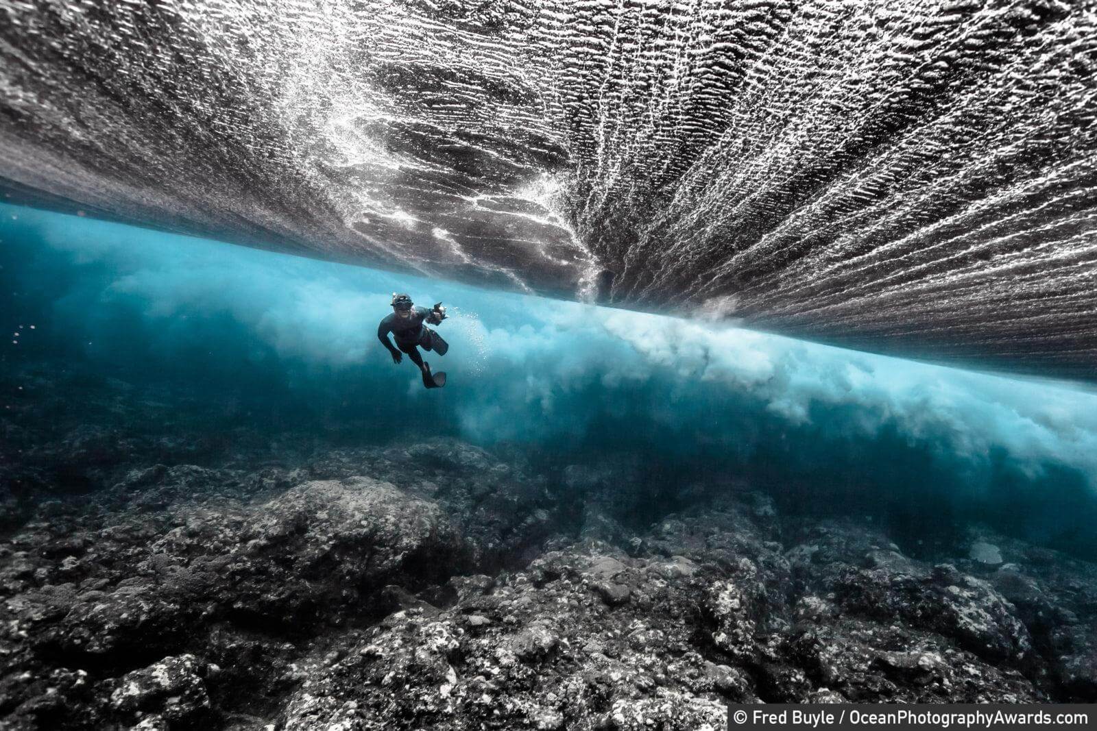 A freediver swims below a breaking wave off Rurutu Island, Autrales, French Polynesia. "We had actually spent nine hours looking for humpback whales and decided to have a quick look at the breaking waves," says photographer Fred Buyle.