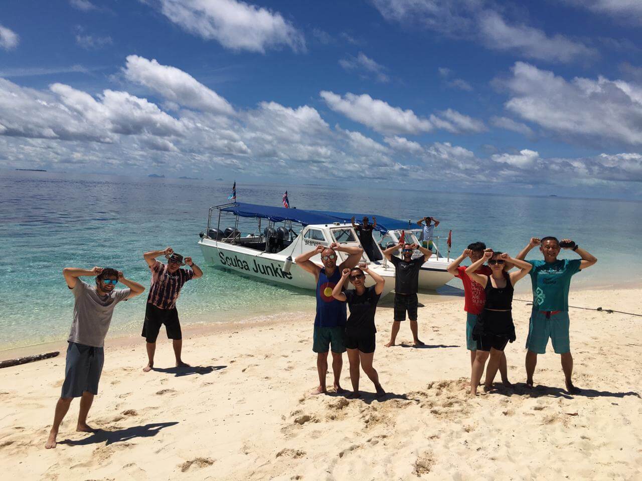 Happy Scuba Junkie Divers at Pulau Sipadan. The group had just seen scalloped hammerhead sharks - a rare species - on a dive. (Photo credit: M Wendels)