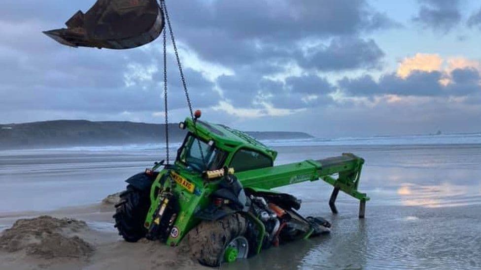 telehandler attempting to remove a dead pilot whale off Perranporth Beach