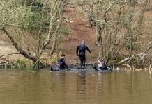 Police divers scouring a pond in Epping Forest as part of the search for a missing student