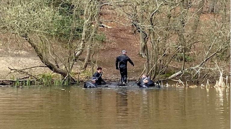 Police divers scouring a pond in Epping Forest as part of the search for a missing student