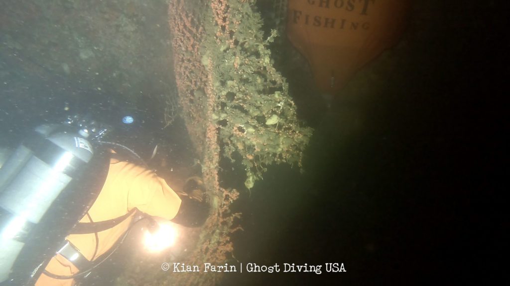 Ghost Diving team member removing monofilament netting from the shipwreck