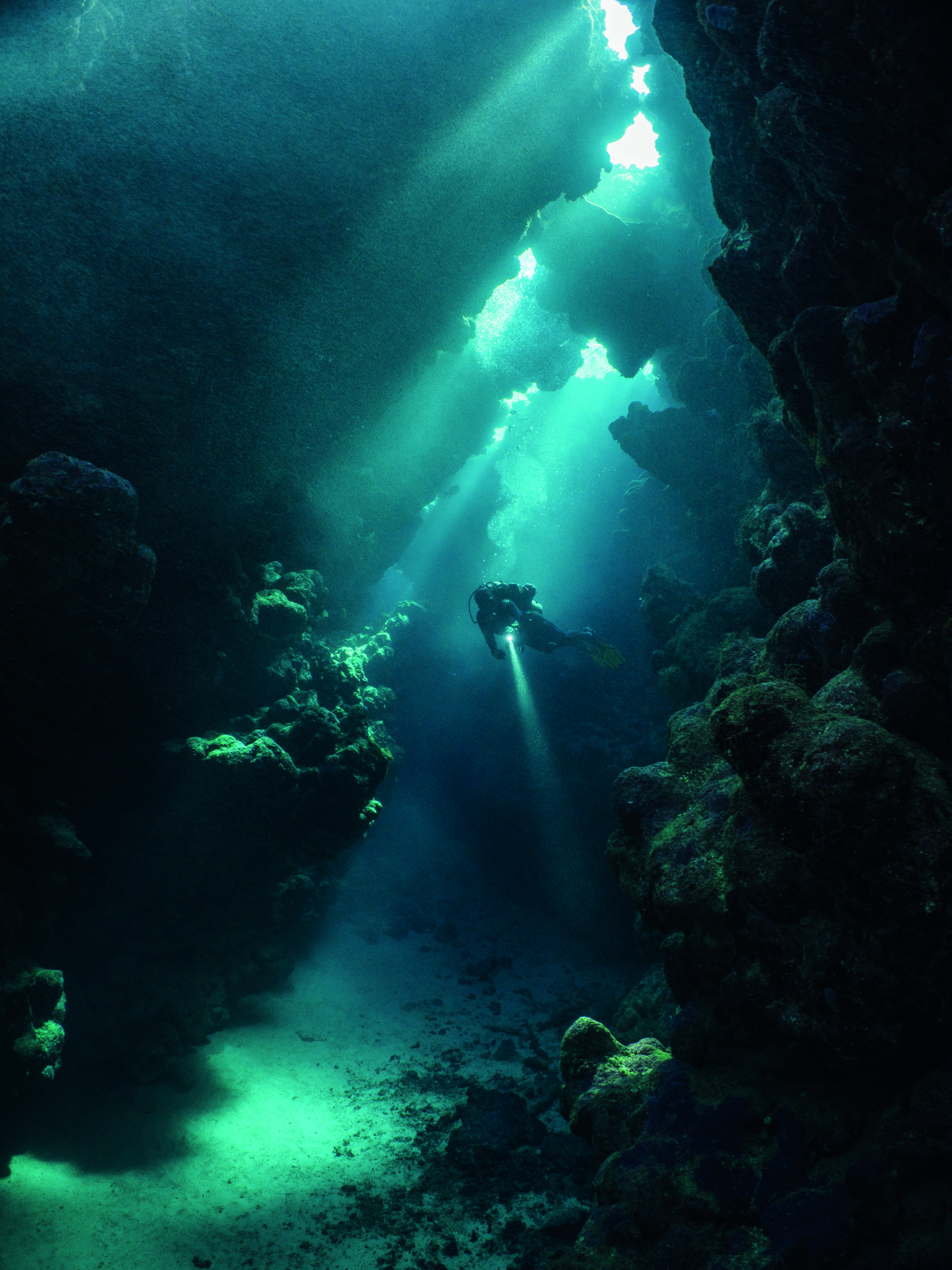 A classic cavern shot. Notice the sunbeams crossing the frame starting in the cavern sealing and finishing on the sand. The divers torch help balancing the image. Sha’ab Claudia, Egypt