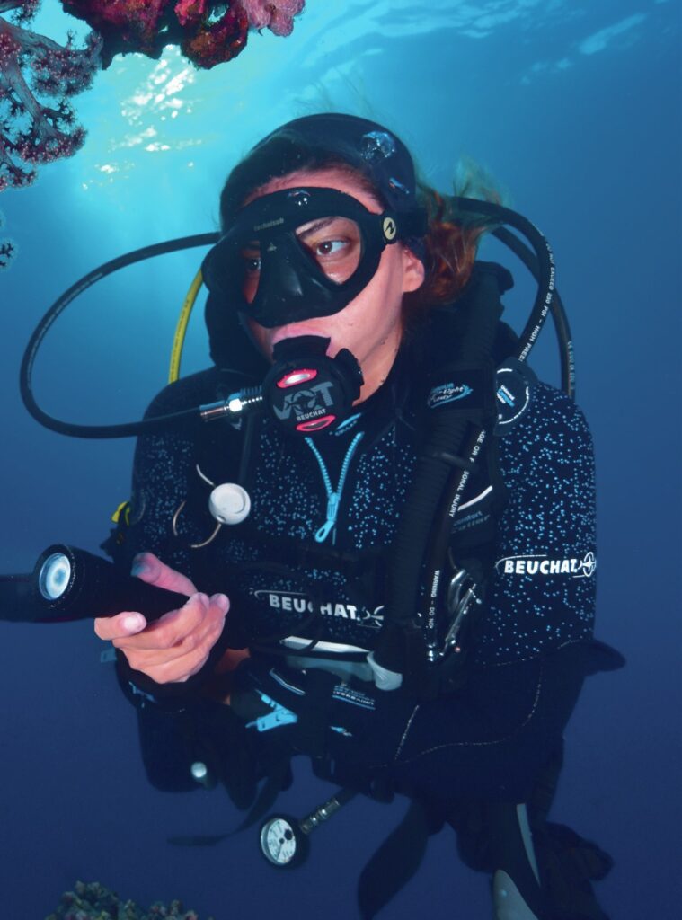 Scuba diver looking at soft coral
