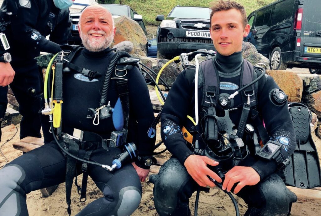 Two Scuba divers sitting together 