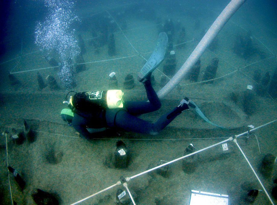 Diver with one of the Stone Age canoes